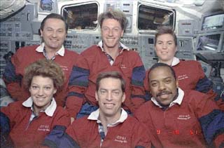 STS-63 crew aboard the Space Shuttle Discovery's flight deck